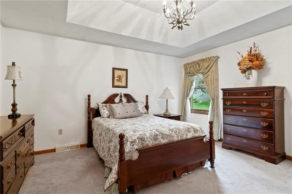 138 Valley Road Eighty Four, PA 15330 - Photo 17 of 33 a bedroom with a bed and a chandelier