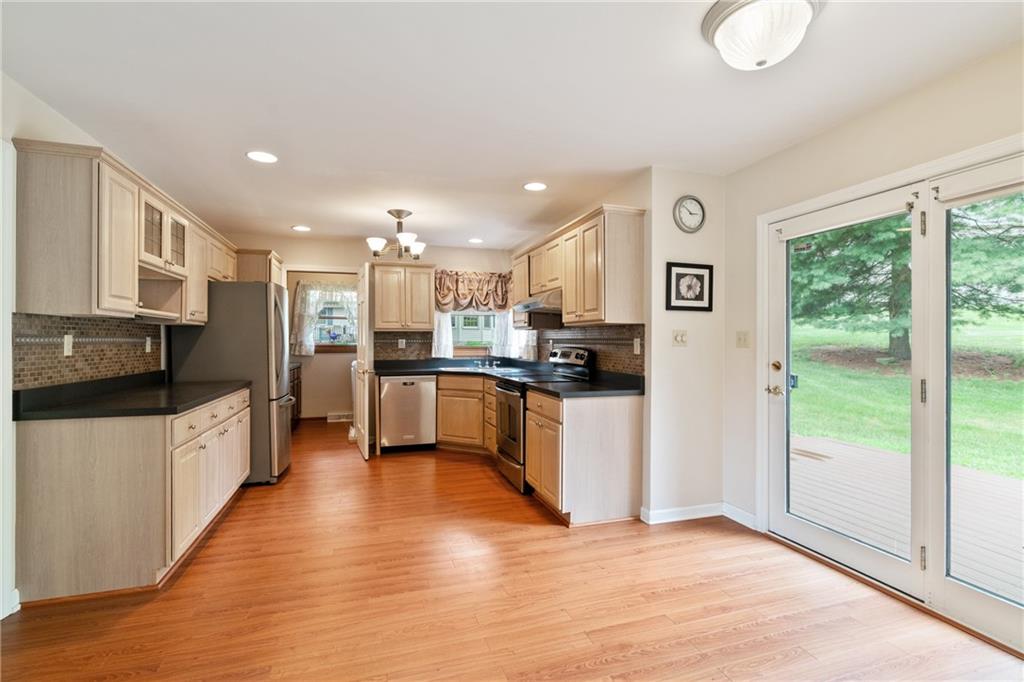 138 Valley Road Eighty Four, PA 15330 - Photo 9 of 33 a kitchen with stainless steel appliances granite countertop a refrigerator a sink a stove top oven a counter space and cabinets