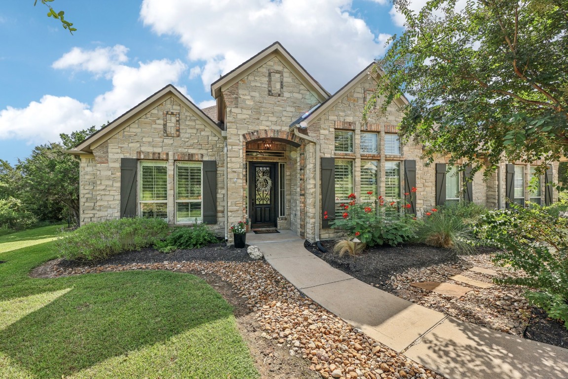 a front view of a house with garden