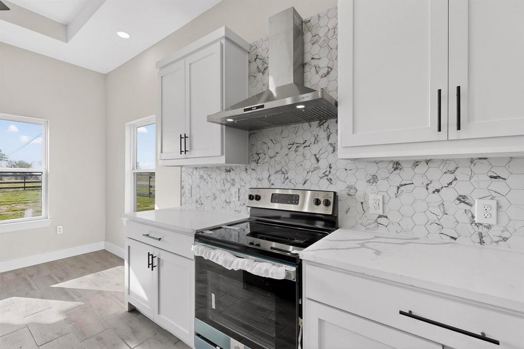100 Diamond T Ranch Road Trinidad, TX 75163 - Photo 11 of 36 a kitchen with a stove and a white cabinets