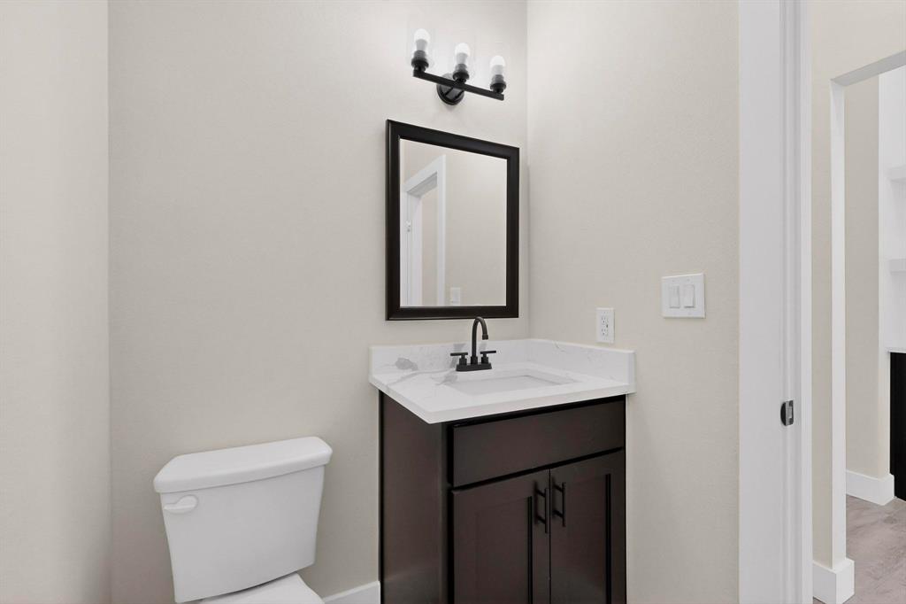100 Diamond T Ranch Road Trinidad, TX 75163 - Photo 16 of 36 a bathroom with a toilet sink and mirror