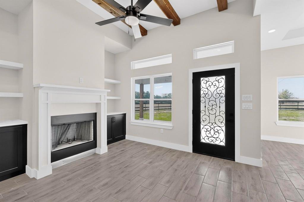 100 Diamond T Ranch Road Trinidad, TX 75163 - Photo 5 of 36 an empty room with windows fireplace and wooden floor