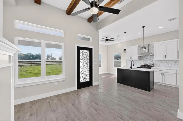 a large kitchen with a large window appliances and cabinets