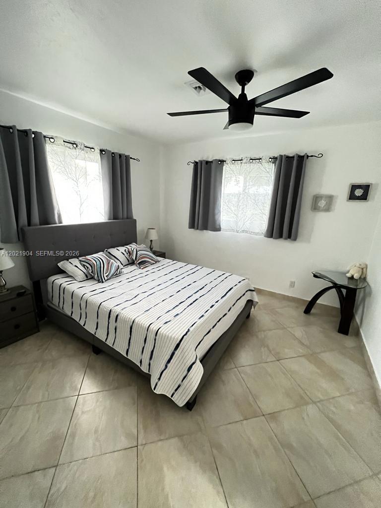 3324 Lakeview Boulevard Delray Beach, FL 33445 - Photo 23 of 36 a bedroom with a bed and window
