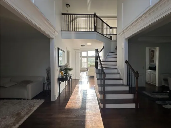 a view of entryway and hall with wooden floor
