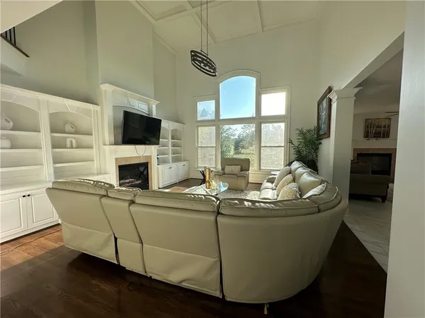 a living room with furniture a fireplace and a flat screen tv