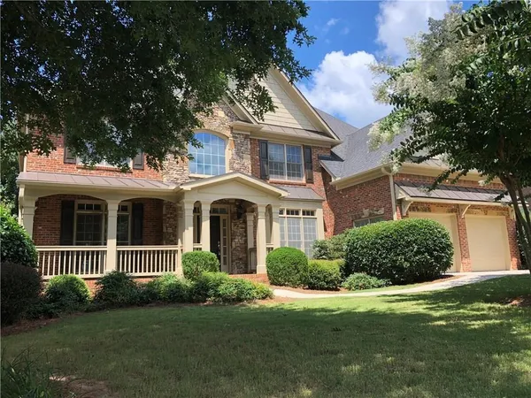 a front view of a house with a garden