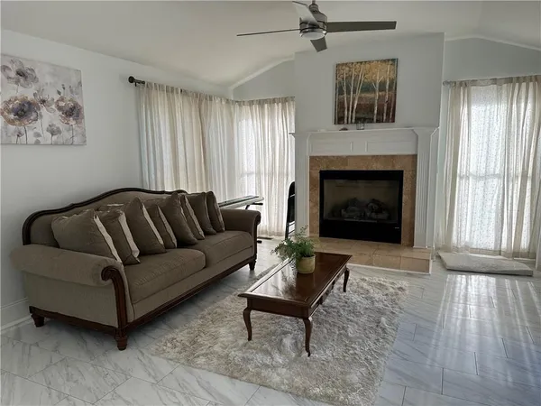 a living room with furniture and a fireplace