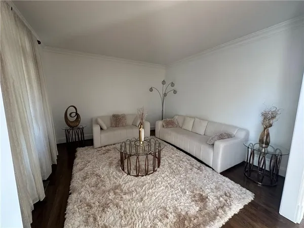 a living room with furniture a rug and a table