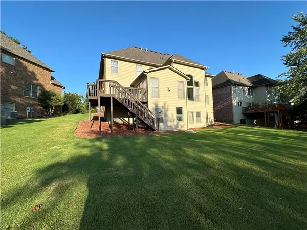 a view of a house with a small yard and sitting area