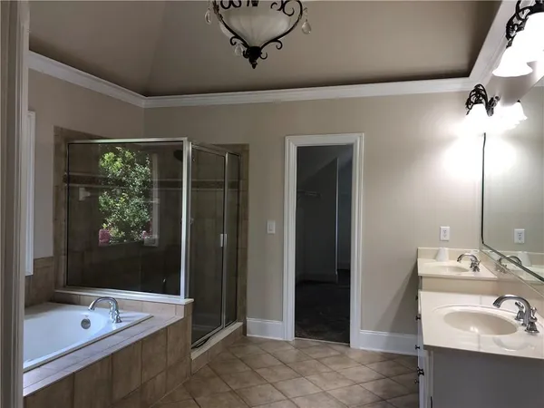 a bathroom with a tub sink and mirror