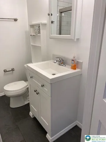a view of bathroom with a sink and a toilet