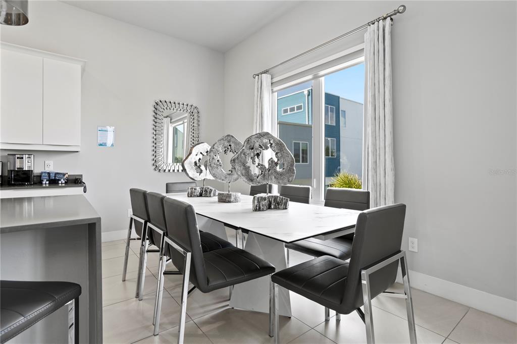 7770 Sandy Ridge Drive, Unit 207 Reunion, FL 34747 - Photo 15 of 61 a view of a dining room with furniture and wooden floor