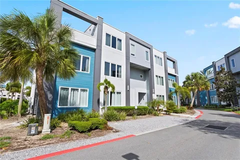 a front view of multi story residential apartment building with yard and green space