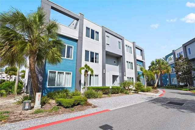 a front view of multi story residential apartment building with yard and green space