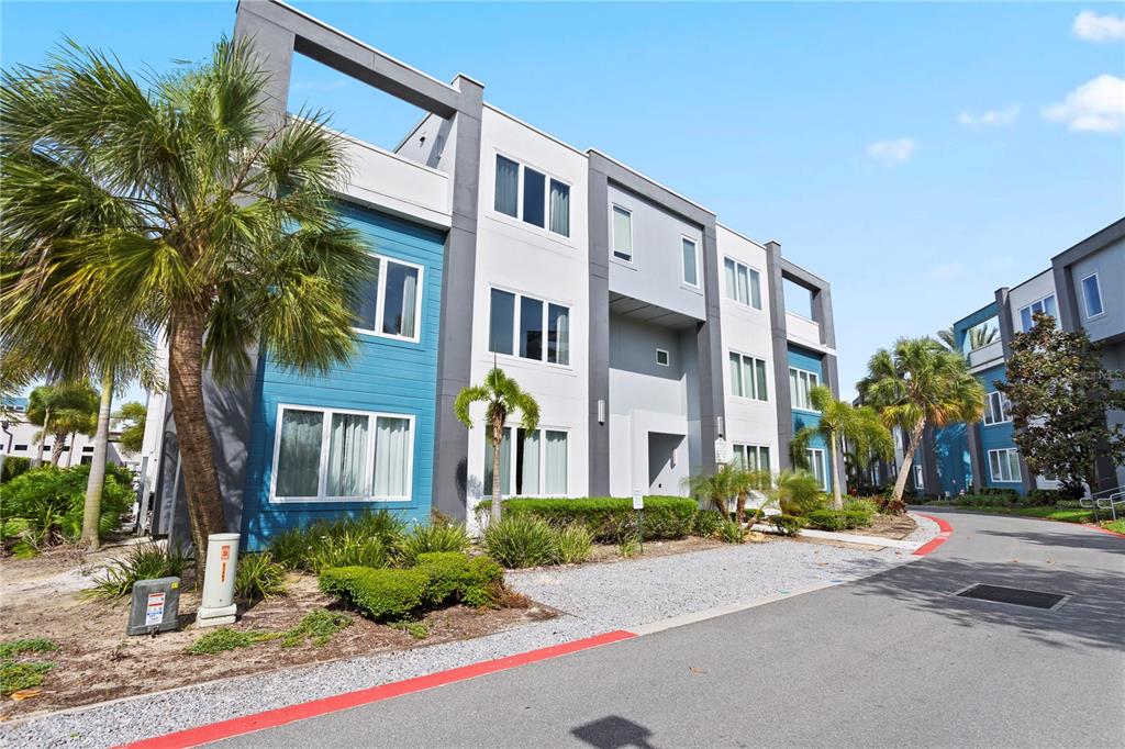 7770 Sandy Ridge Drive, Unit 207 Reunion, FL 34747 - Photo 2 of 61 a front view of multi story residential apartment building with yard and green space