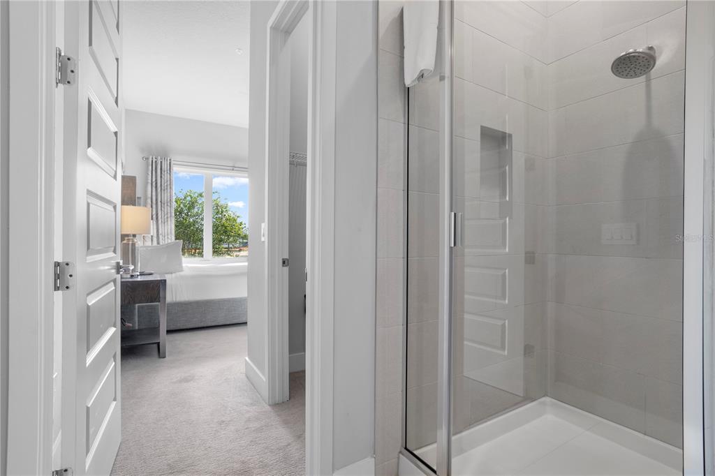 7770 Sandy Ridge Drive, Unit 207 Reunion, FL 34747 - Photo 21 of 61 a bathroom with a tub shower and sink