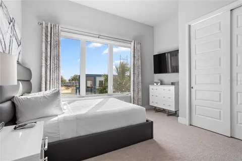 a bedroom with a large bed and a window