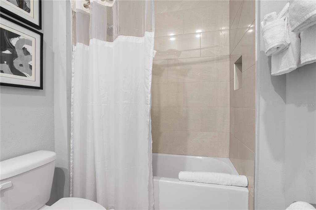 7770 Sandy Ridge Drive, Unit 207 Reunion, FL 34747 - Photo 27 of 61 a bathroom with a shower and toilet