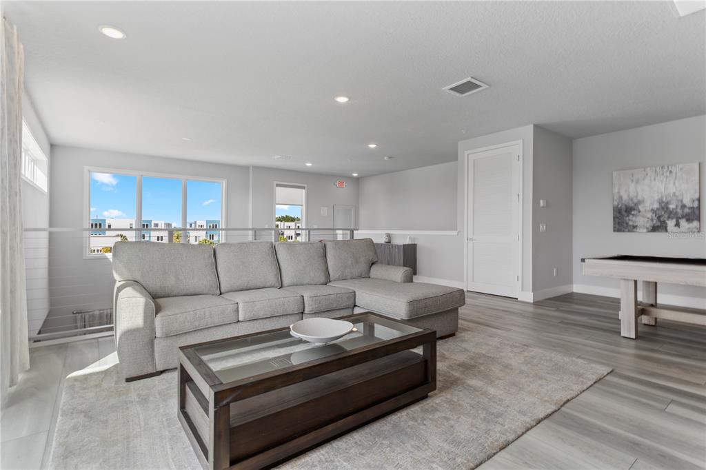 7770 Sandy Ridge Drive, Unit 207 Reunion, FL 34747 - Photo 32 of 61 a living room with furniture and a table