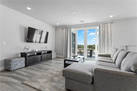 a bedroom with bed and a painting on the wall