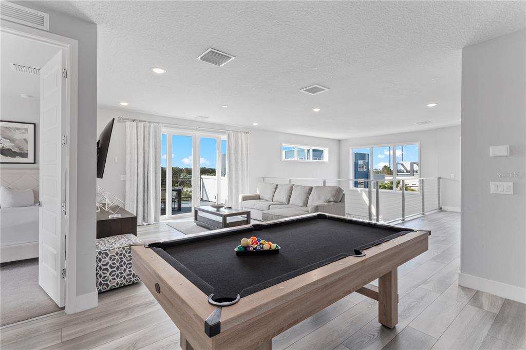 7770 Sandy Ridge Drive, Unit 207 Reunion, FL 34747 - Photo 36 of 61 a living room with pool table and a couch