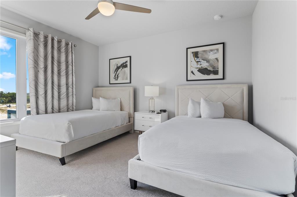 7770 Sandy Ridge Drive, Unit 207 Reunion, FL 34747 - Photo 37 of 61 a bedroom with bed and painting on the wall