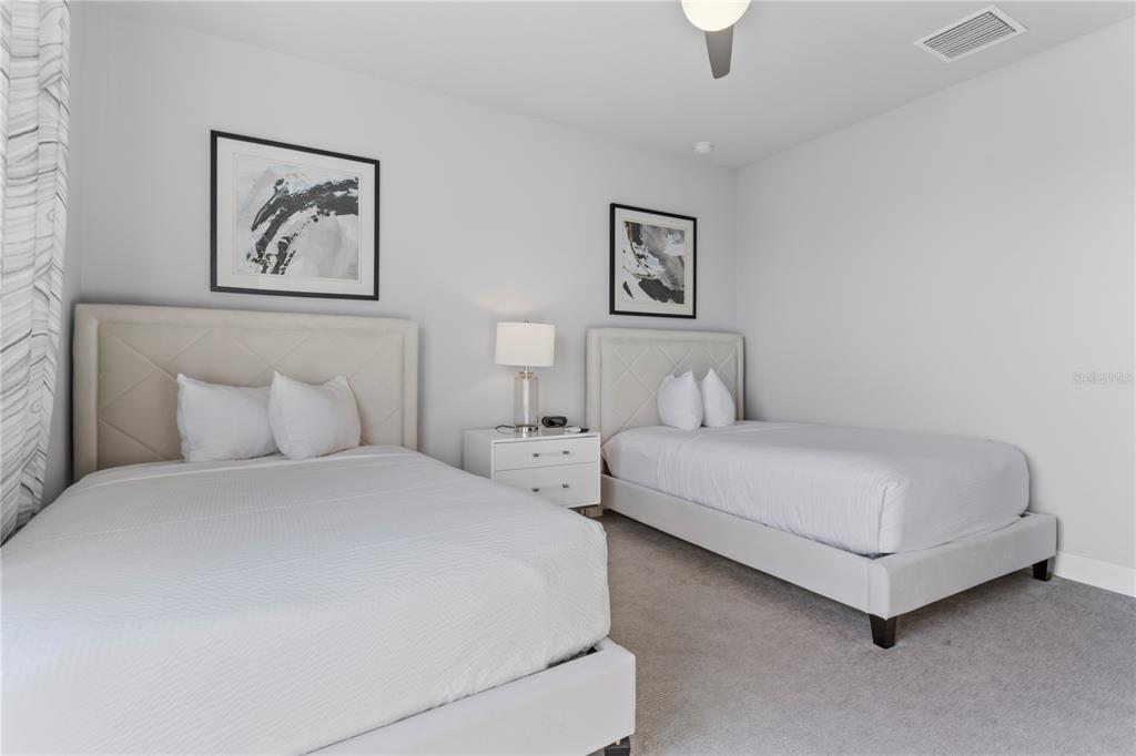 7770 Sandy Ridge Drive, Unit 207 Reunion, FL 34747 - Photo 38 of 61 a bedroom with bed and a painting on the wall