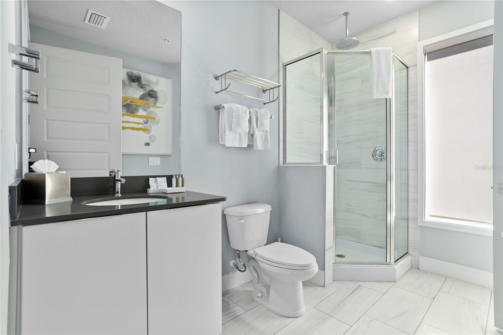 7770 Sandy Ridge Drive, Unit 207 Reunion, FL 34747 - Photo 39 of 61 a bathroom with a toilet sink and shower