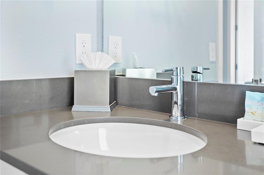 7770 Sandy Ridge Drive, Unit 207 Reunion, FL 34747 - Photo 40 of 61 a bathroom with a sink and a mirror