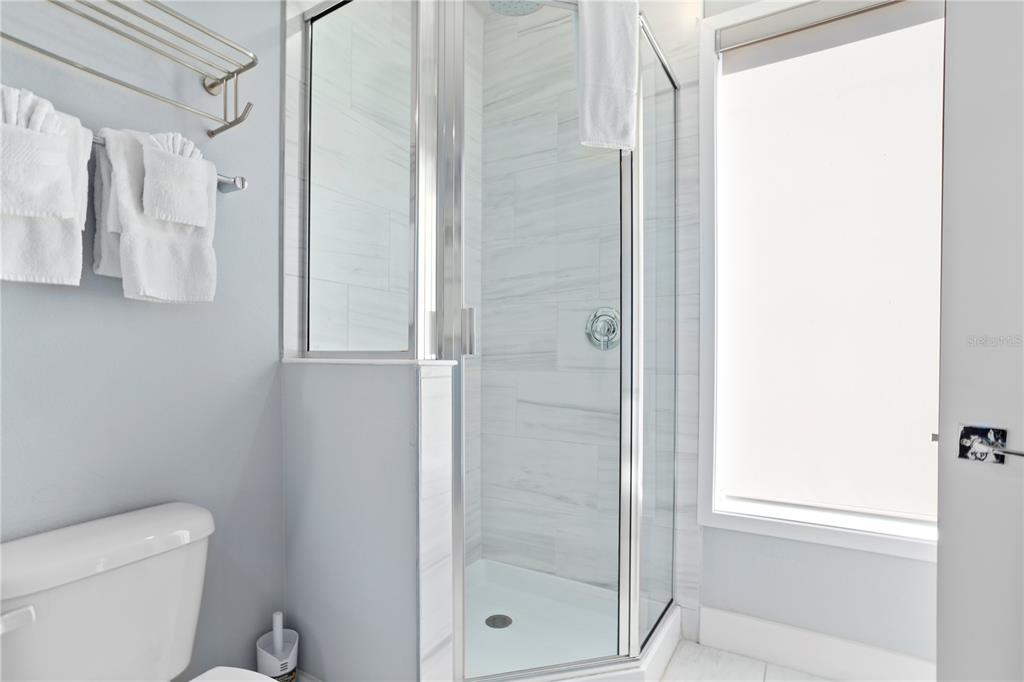 7770 Sandy Ridge Drive, Unit 207 Reunion, FL 34747 - Photo 41 of 61 a bathroom with a shower and toilet