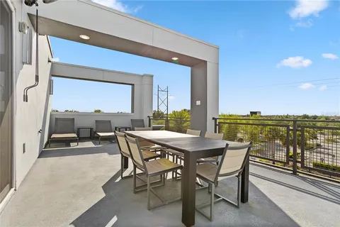 a large white kitchen with lots of counter space and glass windows