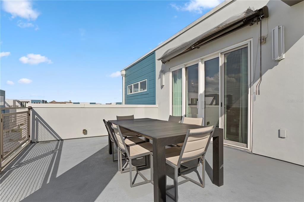 7770 Sandy Ridge Drive, Unit 207 Reunion, FL 34747 - Photo 45 of 61 a table and chairs in front of a house