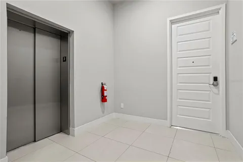 a kitchen with stainless steel appliances kitchen island granite countertop a refrigerator a stove a sink a dining table and chairs