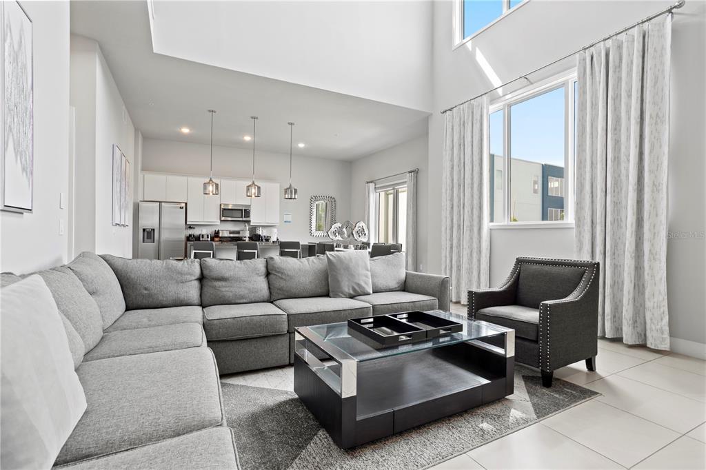 7770 Sandy Ridge Drive, Unit 207 Reunion, FL 34747 - Photo 8 of 61 a living room with furniture and a window