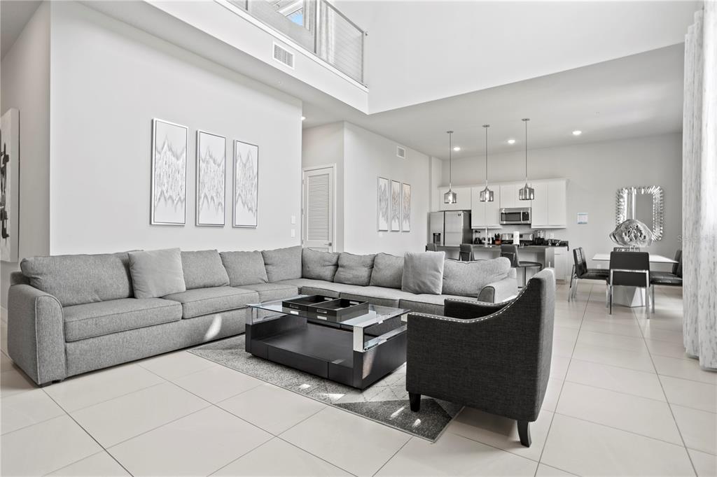 7770 Sandy Ridge Drive, Unit 207 Reunion, FL 34747 - Photo 9 of 61 a living room with furniture and a large window