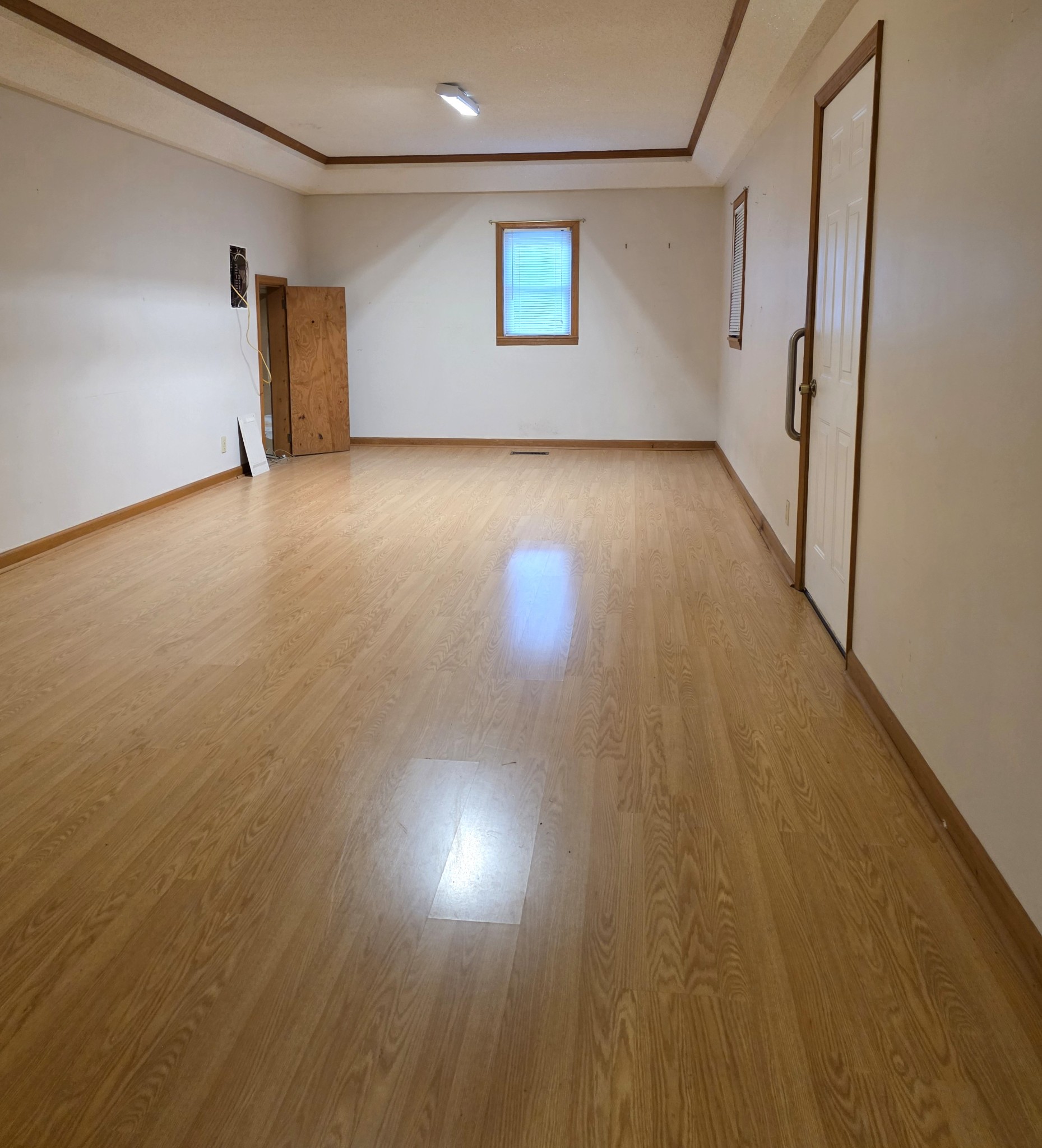 1117 Essie Cleek Road Tullahoma, TN 37388 - Photo 24 of 29 an empty room with wooden floor and windows