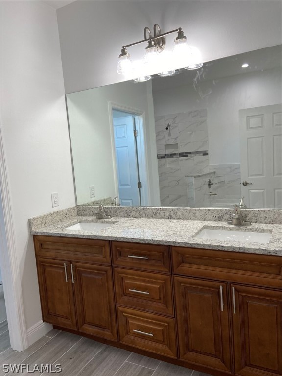 5029 Bristo Street Lehigh Acres, FL 33971 - Photo 12 of 14 a bathroom with a granite countertop sink and a mirror