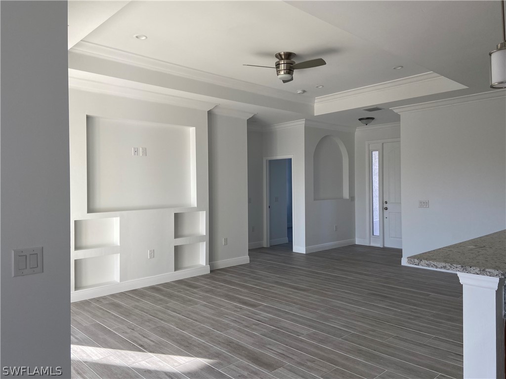 5029 Bristo Street Lehigh Acres, FL 33971 - Photo 4 of 14 a view of empty room with wooden floor and fan