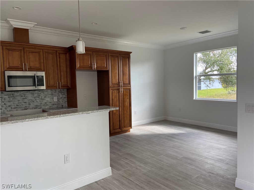 5029 Bristo Street Lehigh Acres, FL 33971 - Photo 7 of 14 a view of a kitchen with a sink and a refrigerator