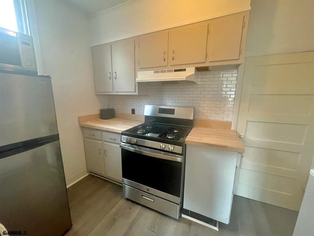 1050 Shore Road Linwood, NJ 08221 - Photo 4 of 6 a kitchen with wooden cabinets and a stove top oven