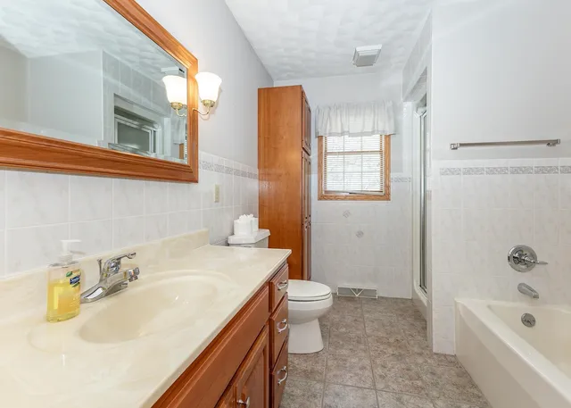 an empty room with closet and a chandelier fan