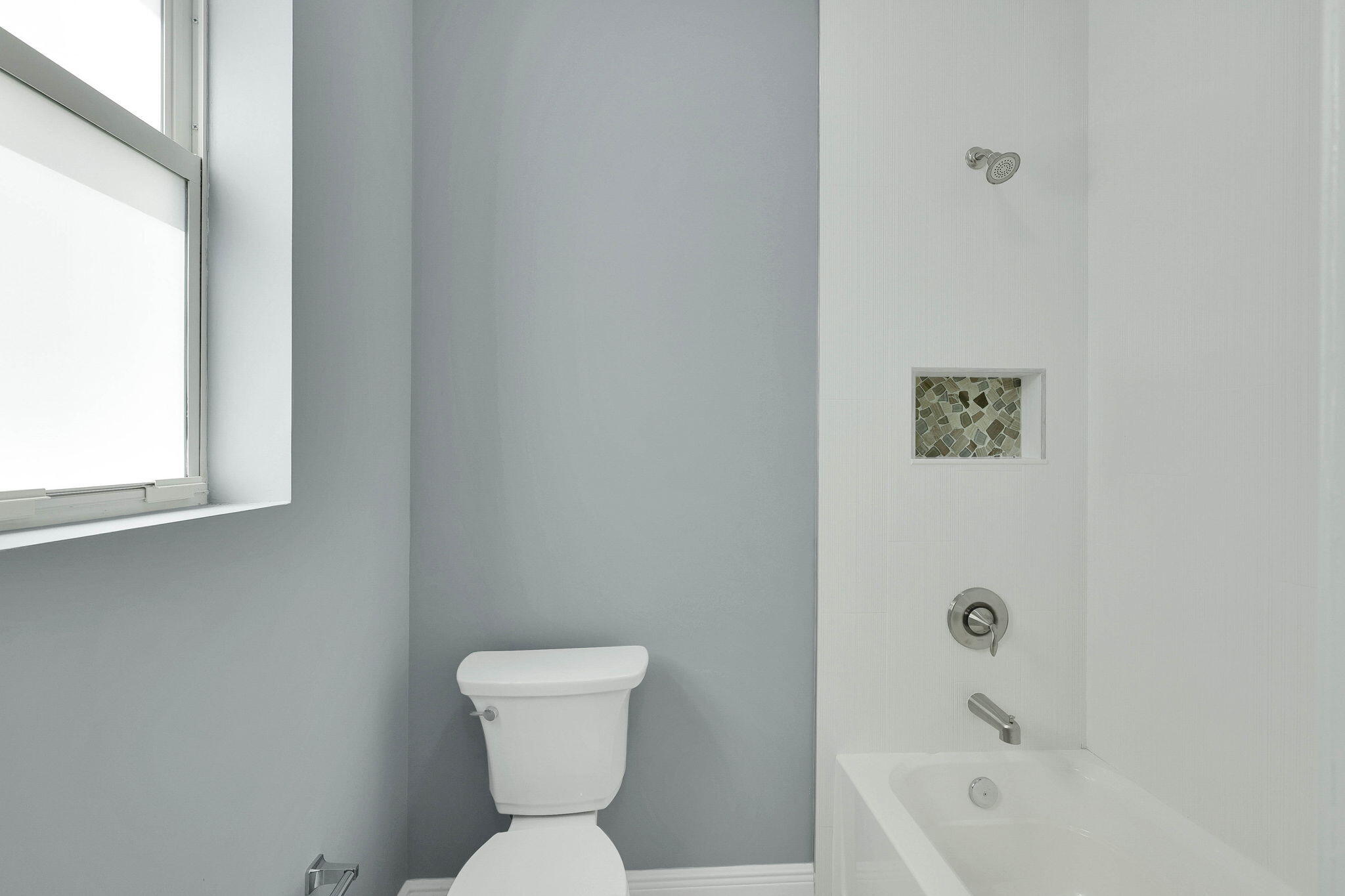 1749 Southwest California Boulevard Port St. Lucie, FL 34953 - Photo 18 of 33 a white toilet sitting next to a bath tub