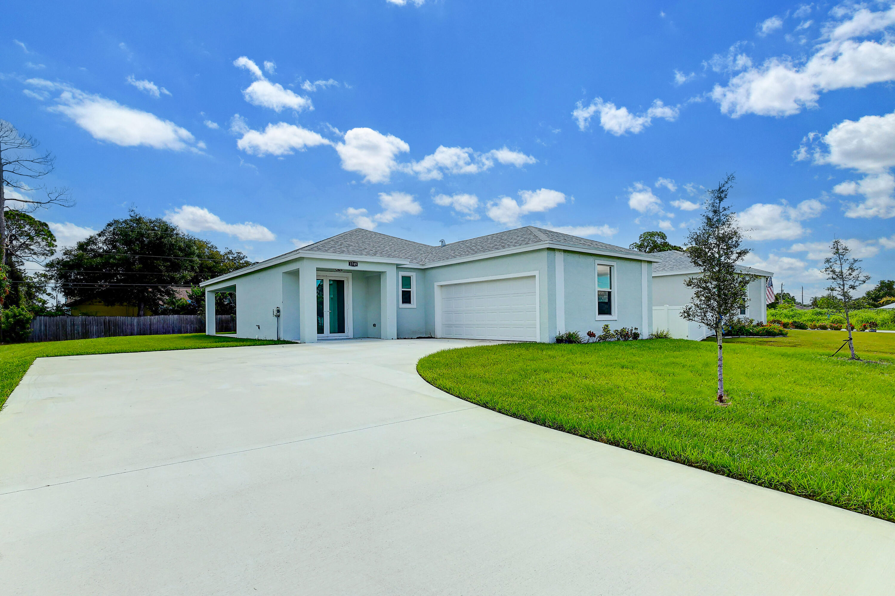 1749 Southwest California Boulevard Port St. Lucie, FL 34953 - Photo 2 of 33 a front view of house with yard and green space