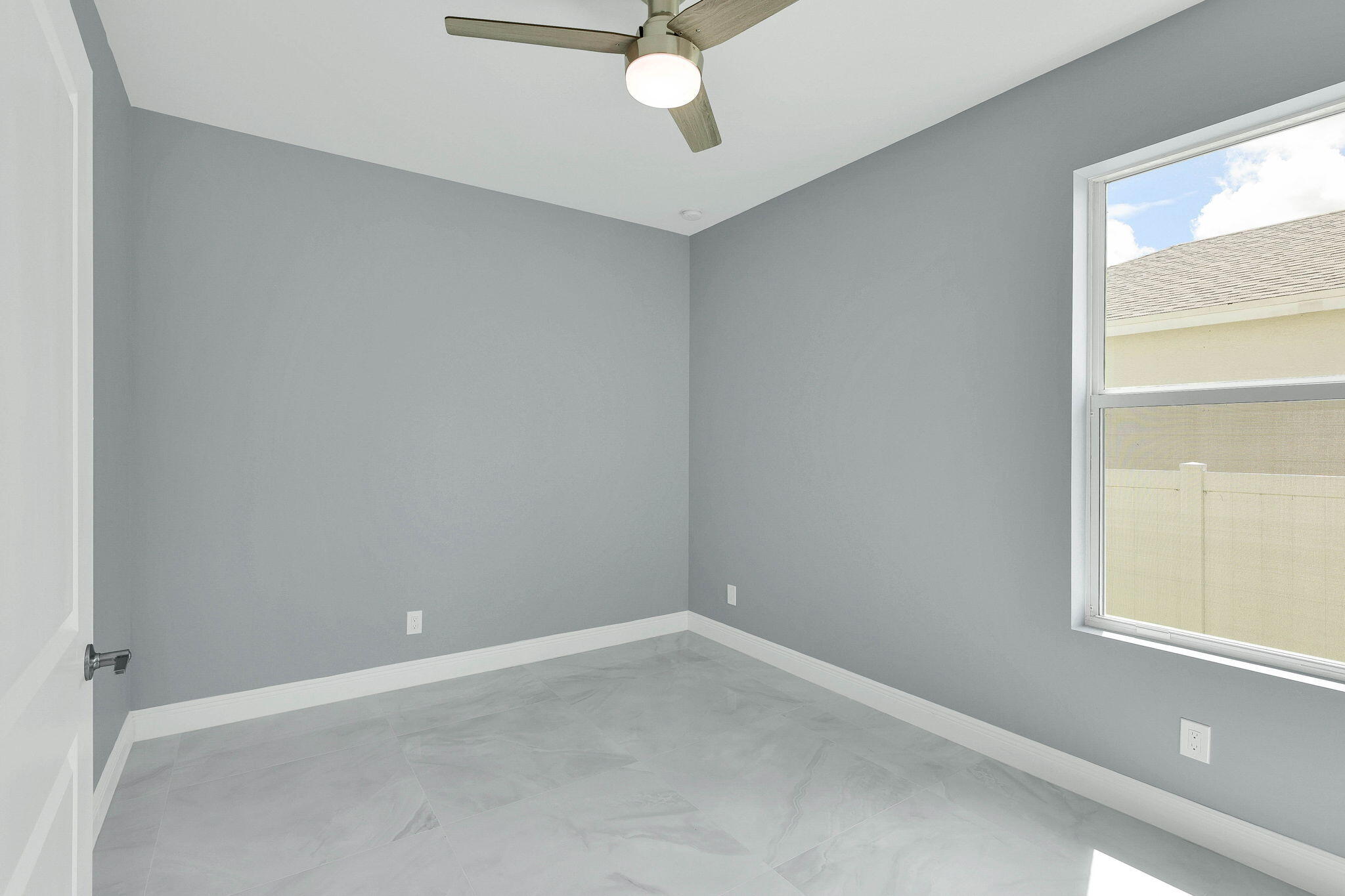 1749 Southwest California Boulevard Port St. Lucie, FL 34953 - Photo 21 of 33 an empty room with a window and a fan