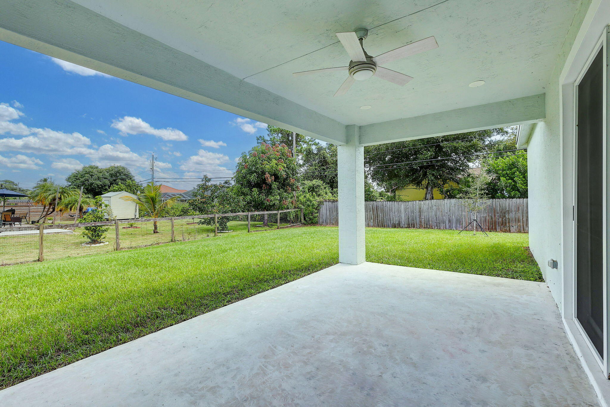 1749 Southwest California Boulevard Port St. Lucie, FL 34953 - Photo 24 of 33 a view of a porch with a big yard