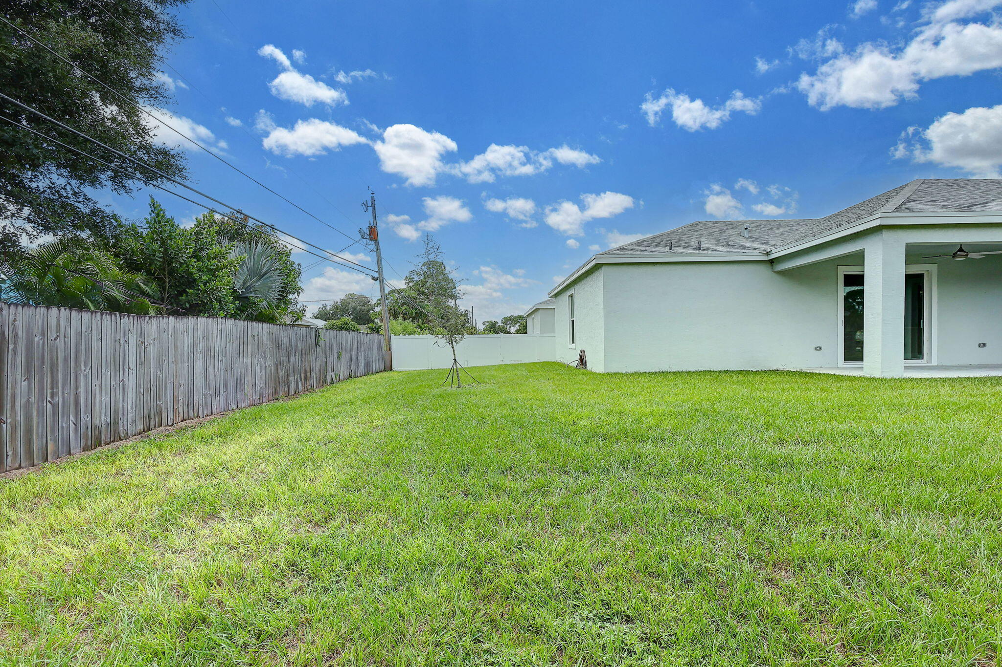 1749 Southwest California Boulevard Port St. Lucie, FL 34953 - Photo 27 of 33 a backyard of a house with lots of green space
