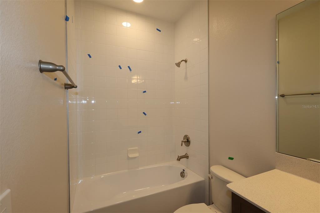 5303 High Line Drive St. Cloud, FL 34771 - Photo 13 of 22 a bathroom with a bathtub and shower