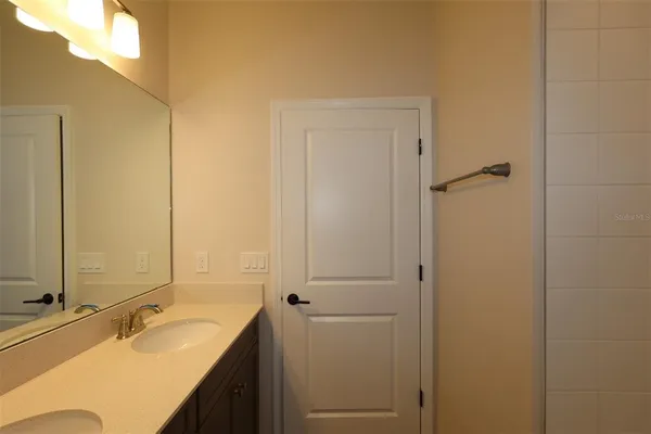 a bathroom with a double vanity sink and mirror