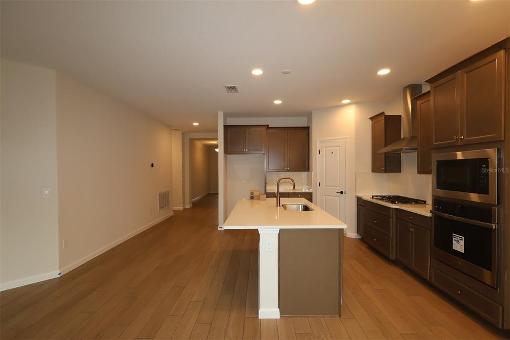 5303 High Line Drive St. Cloud, FL 34771 - Photo 2 of 22 a large kitchen with a large counter top appliances and cabinets